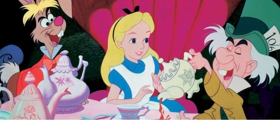 An image from the 1951 Disney cartoon version of Alice in Wonderland. The Mad Hatter is holding a teapot, pouring tea into a glass for Alice, while the Hare looks onward.