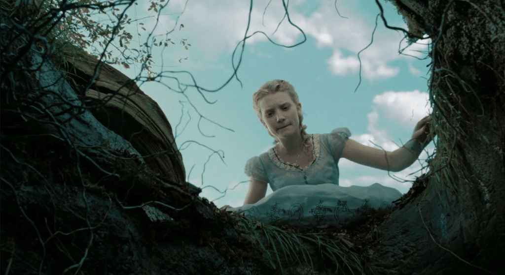 Alice looks down the rabbit hole in "Alice in Wonderland"