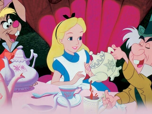 Still image of Alice, the March Hare, and the Mad Hatter drinking tea from the 1951 Disney film "Alice in Wonderland".