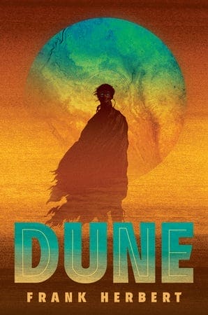 Cover of Penguin deluxe hardcover edition of "Dune" by Frank Herbert, featuring a cloaked figure standing in a desert environment with a planet looming in the background.