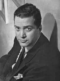 Black and white photograph of Hugo Award-winning science fiction author Alfred Bester, wearing a suit and tie.