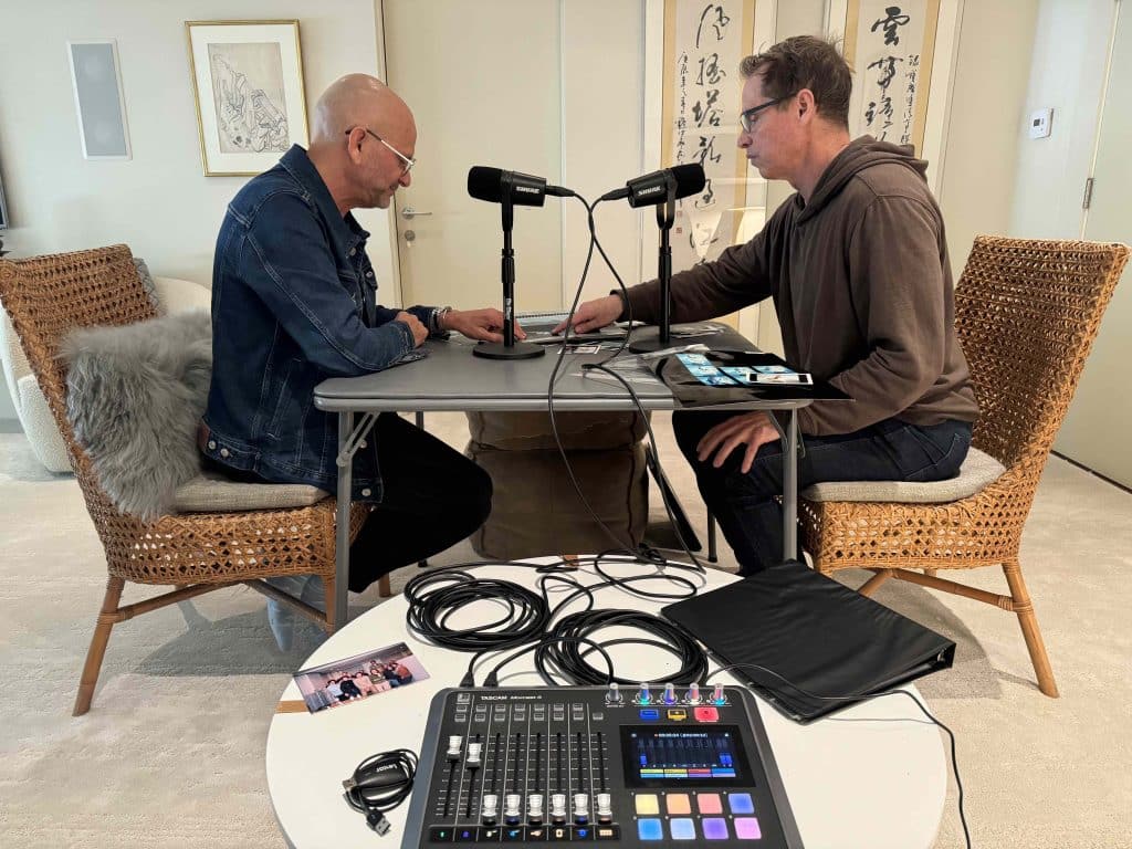 Photograph of Frank Beddor and Eshel Ezer looking at pictures and recording the podcast. 