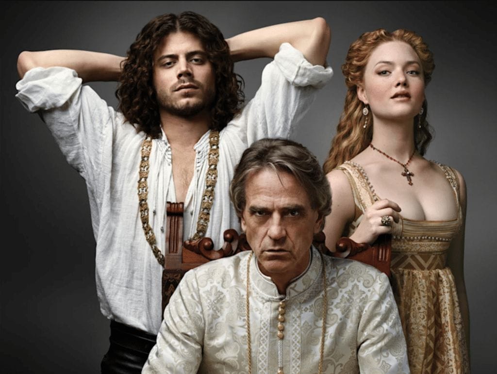 Promotional image from the Showtime series "The Borgias" featuring Francois Arnaud as Cesare Borgia, Holliday Grainger as Lucrezia Borgia, and Jeremy Irons as Rodrigo Borgia.  
