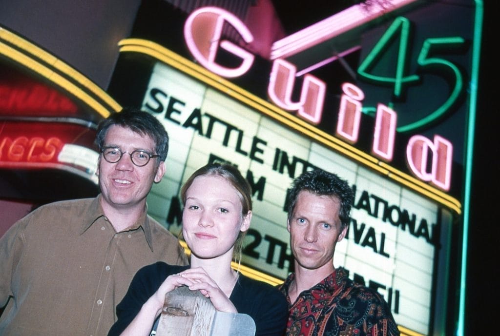 Photograph of director Michael Steinberg, actor Julia Stiles, and producer Frank Beddor in front of a movie theater marquee at the Seattle Internation Film Festival for the 1998 thriller "Wicked".